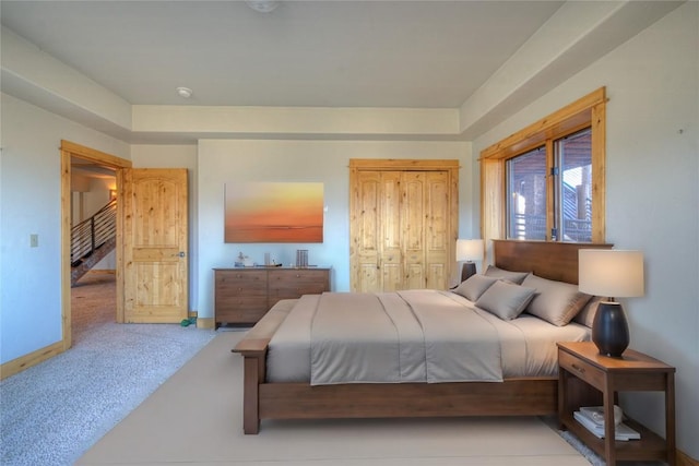 bedroom with light carpet and a closet