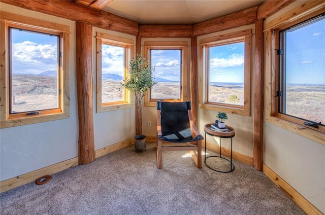 living area with carpet flooring and a mountain view