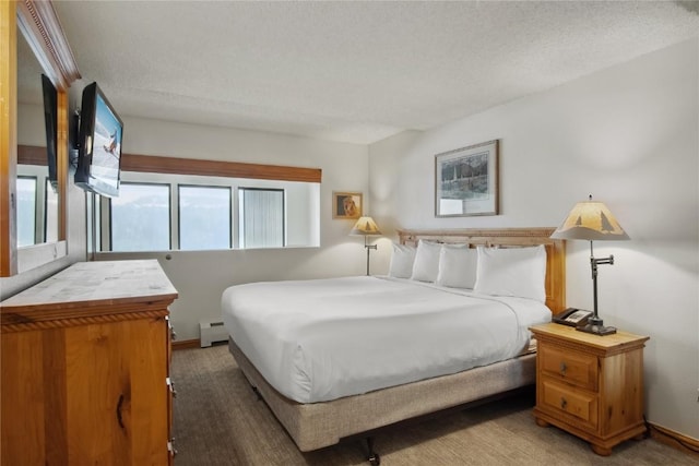 bedroom with carpet flooring, baseboard heating, and a textured ceiling