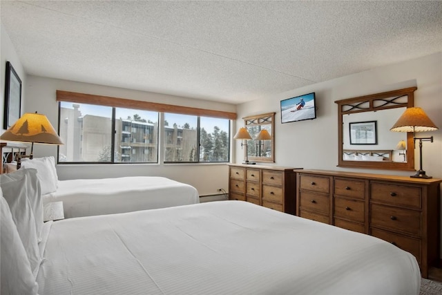 bedroom featuring a textured ceiling and a baseboard radiator