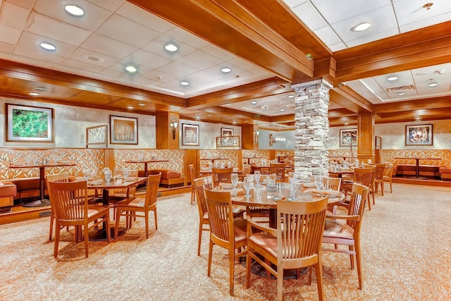 dining room with beamed ceiling and decorative columns