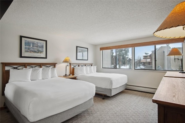 bedroom featuring a textured ceiling and a baseboard radiator