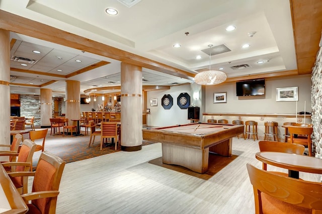 recreation room with a raised ceiling, billiards, and light hardwood / wood-style flooring