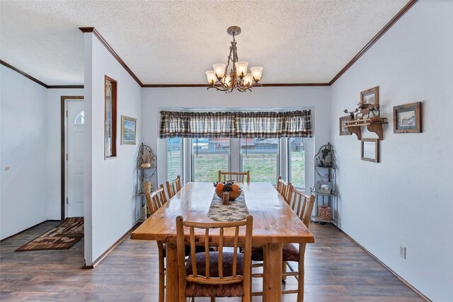 dining room with dark hardwood / wood-style floors, a textured ceiling, and a chandelier