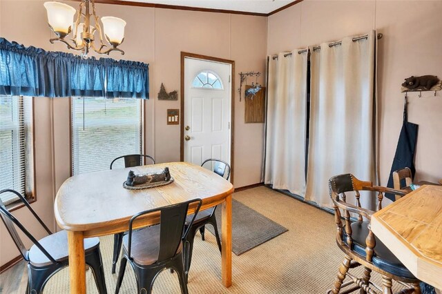 dining area featuring a notable chandelier and ornamental molding