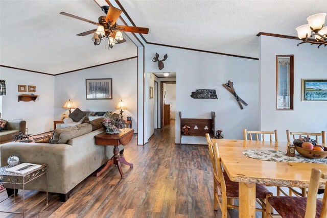 living room featuring dark hardwood / wood-style flooring, ornamental molding, ceiling fan with notable chandelier, a textured ceiling, and lofted ceiling