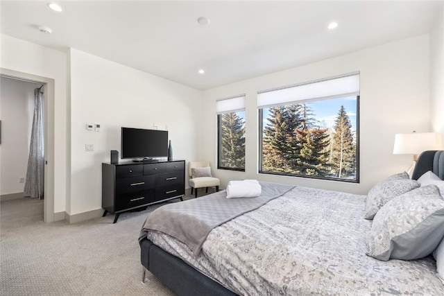 bedroom featuring light carpet, baseboards, and recessed lighting