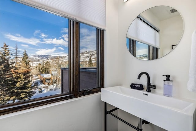 bathroom with visible vents, a mountain view, and a sink