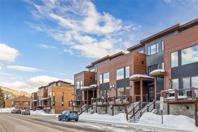 snow covered property featuring a mountain view