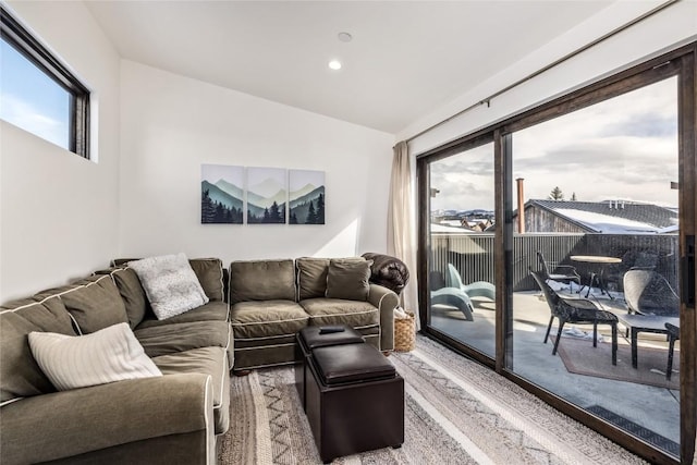 living area featuring lofted ceiling and recessed lighting