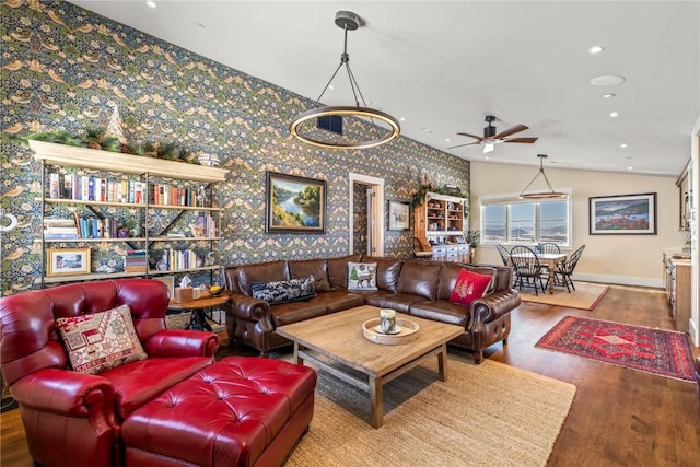 living room with ceiling fan, wood-type flooring, and vaulted ceiling