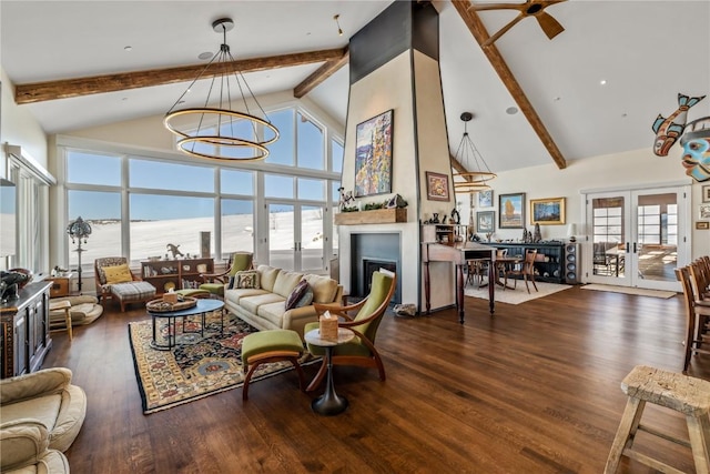 living room featuring high vaulted ceiling, a chandelier, a water view, dark wood-type flooring, and french doors