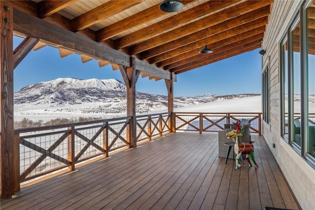 snow covered deck featuring a mountain view