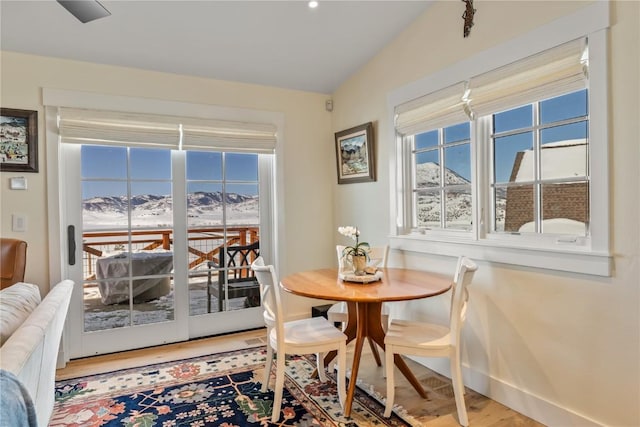 dining area featuring a mountain view and hardwood / wood-style floors