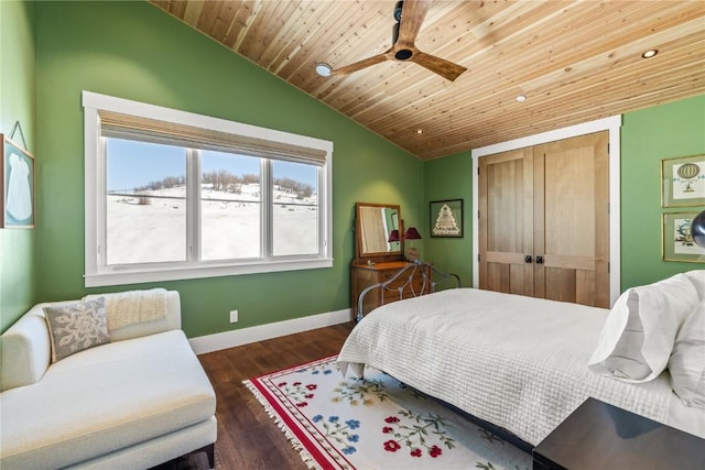 bedroom featuring vaulted ceiling, dark hardwood / wood-style flooring, ceiling fan, wood ceiling, and a closet