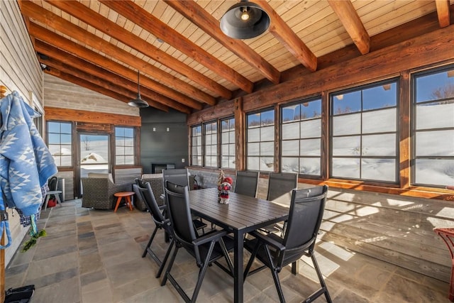 unfurnished dining area featuring lofted ceiling with beams and wooden ceiling