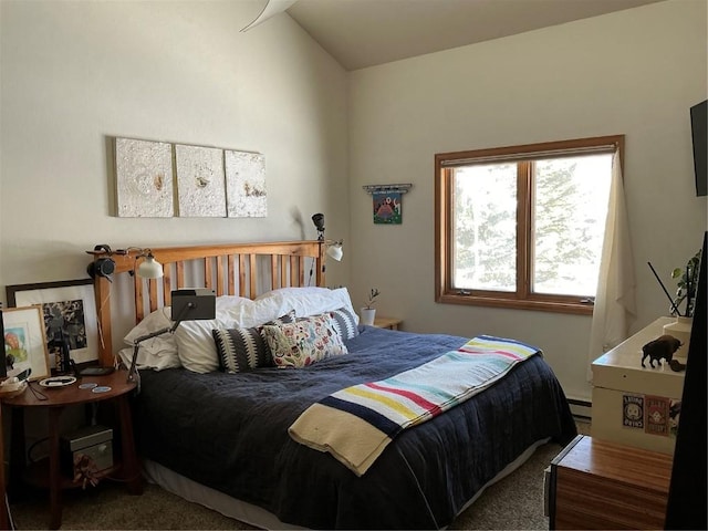 carpeted bedroom with baseboard heating and vaulted ceiling