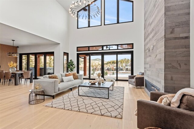 living room featuring hardwood / wood-style floors, a towering ceiling, and french doors