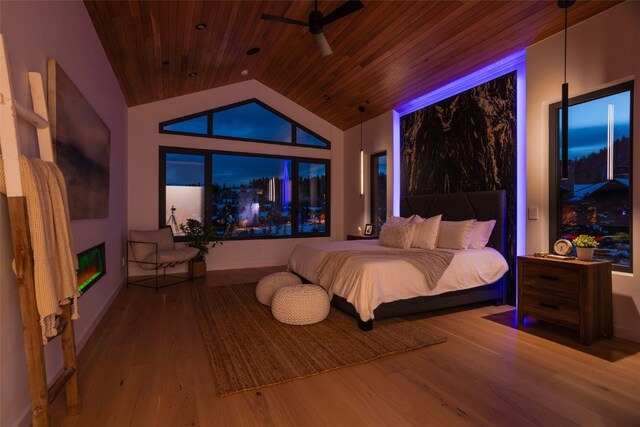 bedroom featuring light hardwood / wood-style floors, vaulted ceiling, and ceiling fan