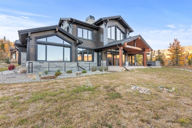 rear view of house featuring a yard