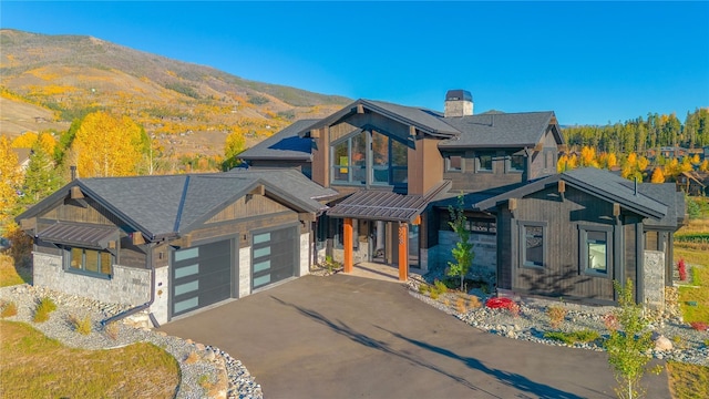 view of front of home with a mountain view and a garage