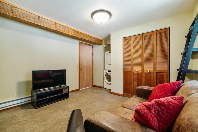 carpeted living room with stacked washer and dryer and a baseboard heating unit