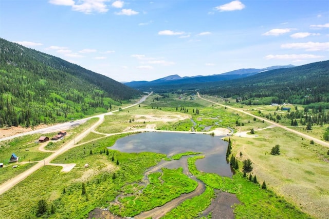 view of community with a water and mountain view and a rural view