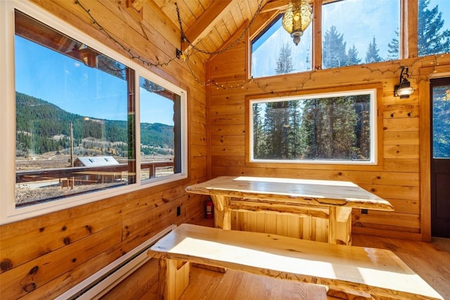 interior space with a mountain view, wood walls, wood ceiling, and vaulted ceiling