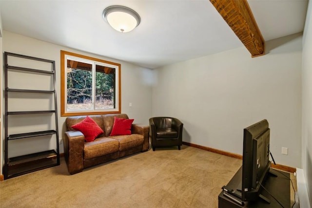 living area featuring beamed ceiling and light colored carpet