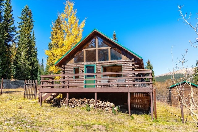 back of property featuring a wooden deck