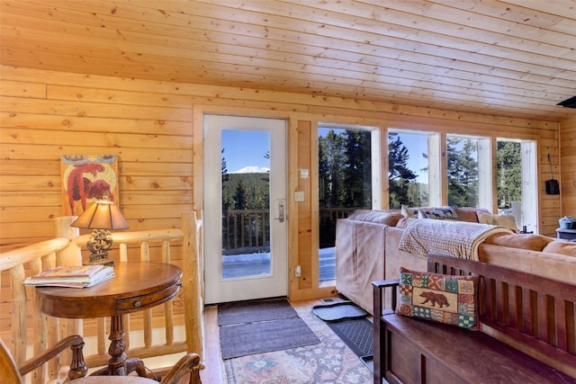 bedroom with wood walls, access to exterior, and wooden ceiling