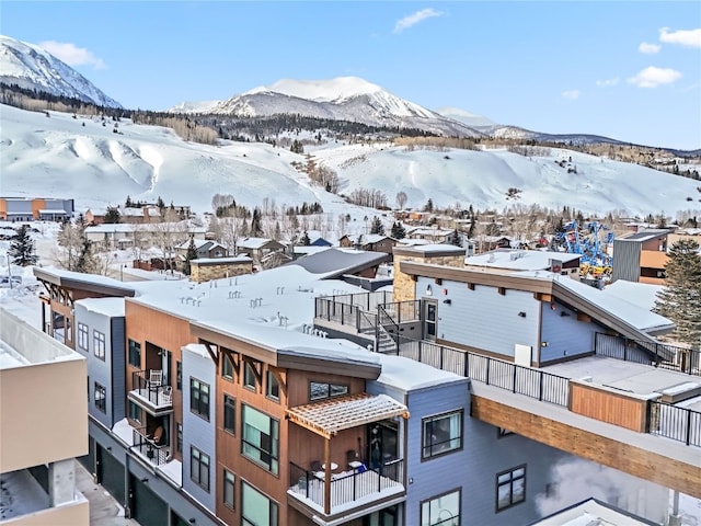 snowy aerial view with a mountain view