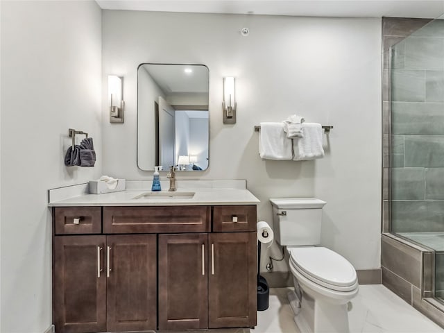 bathroom with walk in shower, vanity, tile patterned flooring, and toilet