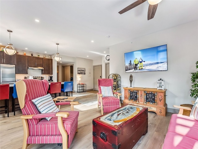 living room with light wood-type flooring and ceiling fan