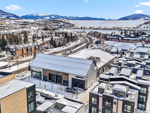 snowy aerial view with a mountain view