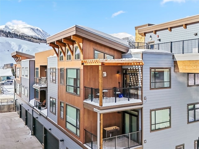 snow covered property featuring a mountain view