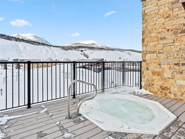 snow covered deck featuring a mountain view