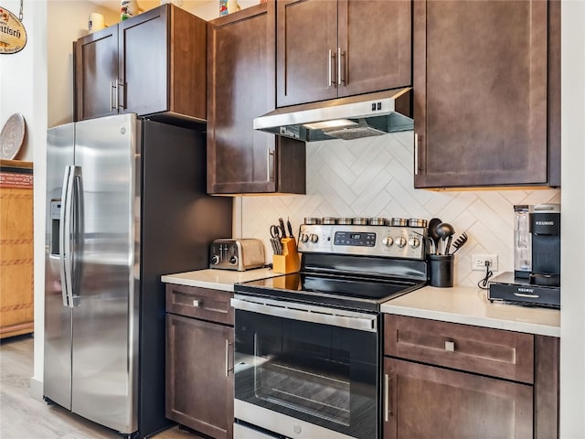 kitchen featuring tasteful backsplash, appliances with stainless steel finishes, and dark brown cabinets