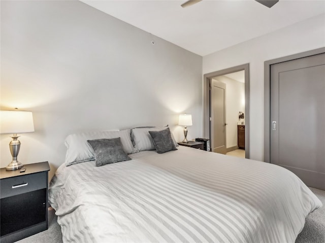 bedroom featuring light carpet and connected bathroom