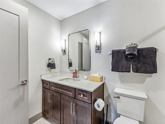 bathroom featuring toilet and vanity