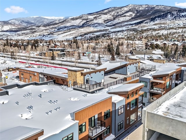 snowy aerial view with a mountain view