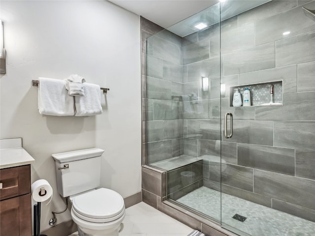 bathroom featuring an enclosed shower, vanity, and toilet