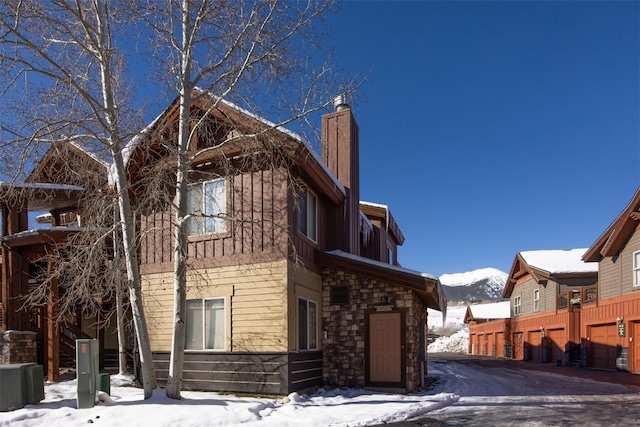 snow covered property featuring a garage