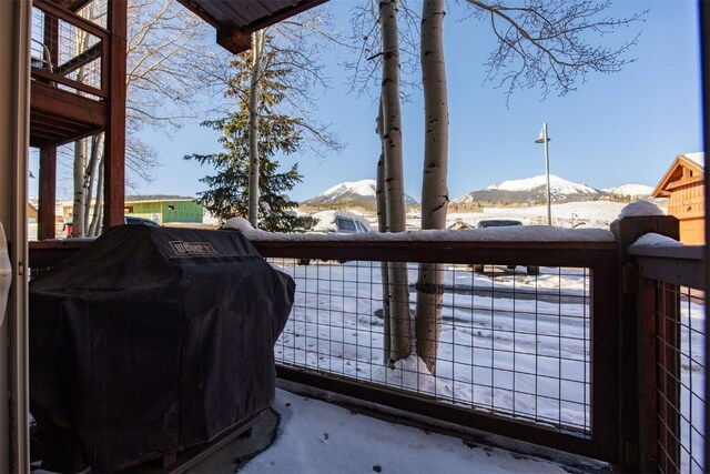 view of snow covered rear of property