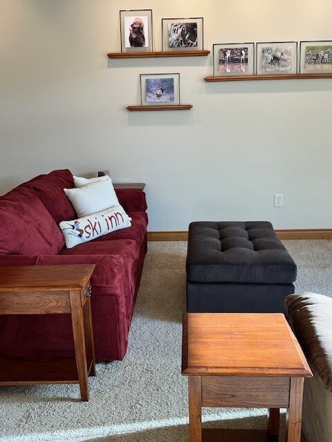 carpeted dining area with plenty of natural light, baseboards, and ceiling fan