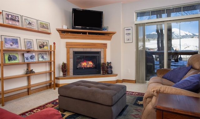 carpeted living room featuring a fireplace and baseboards