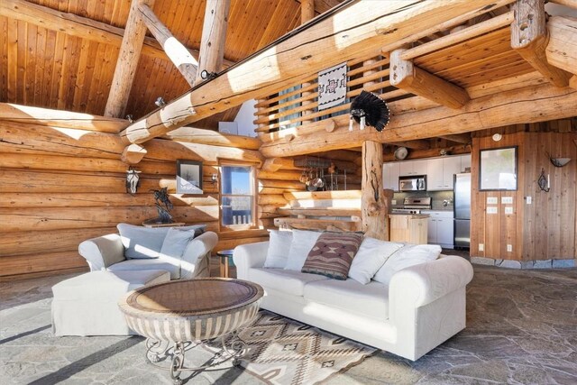 living area with stone finish flooring, a high ceiling, beamed ceiling, and wooden ceiling