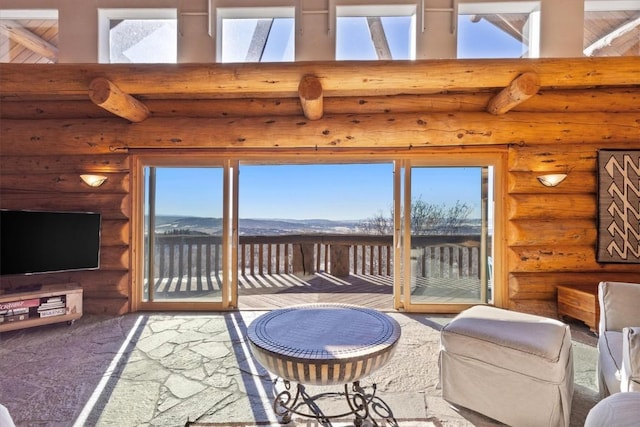 living room featuring a towering ceiling and a mountain view