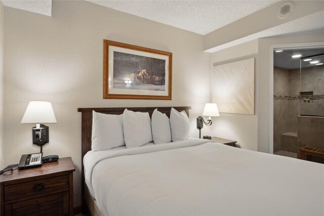 bedroom with a textured ceiling and connected bathroom