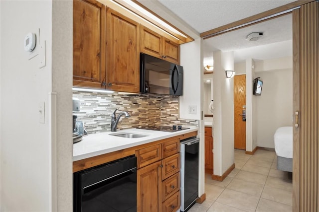 kitchen with sink, wine cooler, backsplash, light tile patterned floors, and black appliances